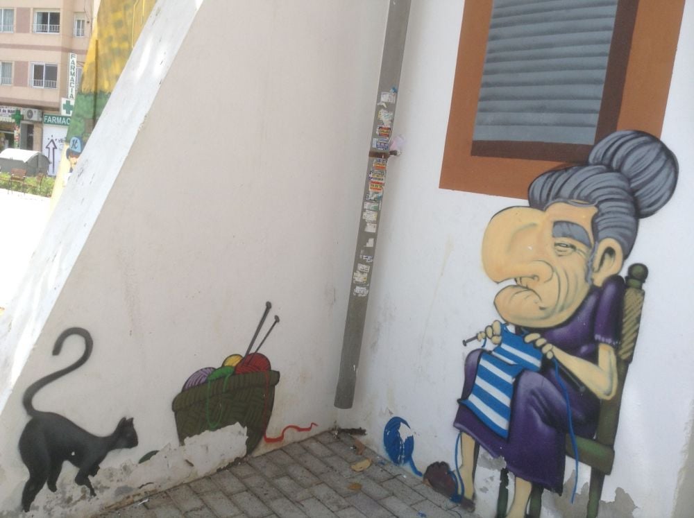 Granny knitting with her lucky black cat in Alicante