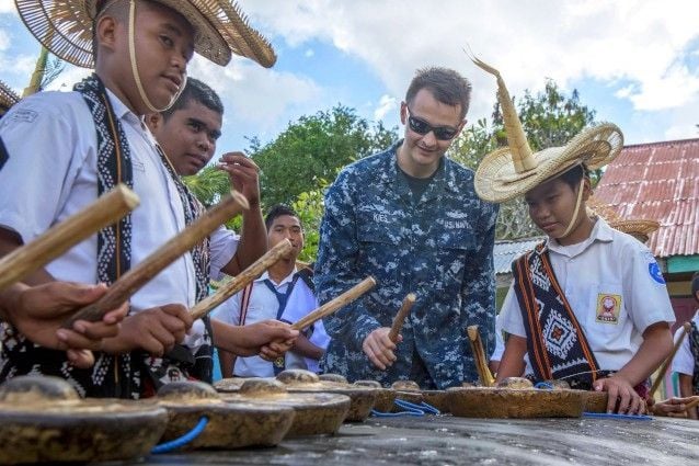 Young Rote musicians in traditional hats