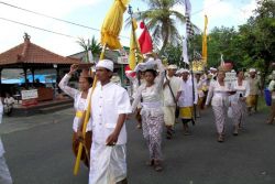 Procession to the temple, lead by priest in white
