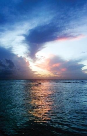 Take in a Bajan sunset over the sea