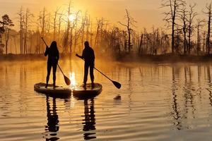 From Riga: Sunrise Kayak or Paddleboard Tour with Pick-Up