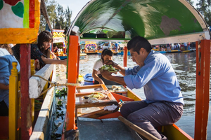 Floating fiesta in Mexico. A colourful boat cruise in the district of Xochimilco