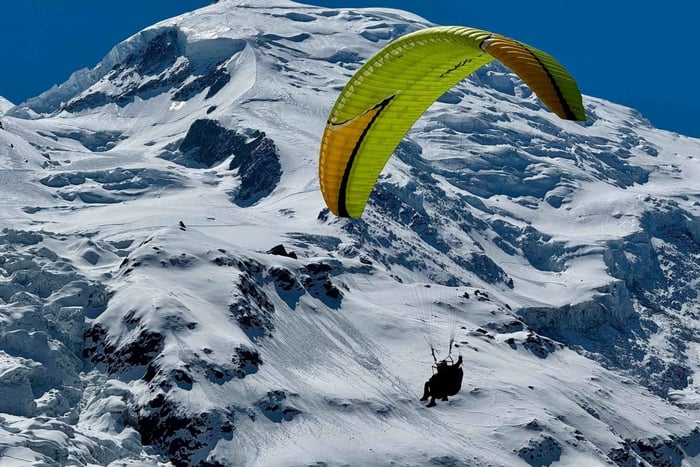 Tandem paragliding flight facing Mont-Blanc