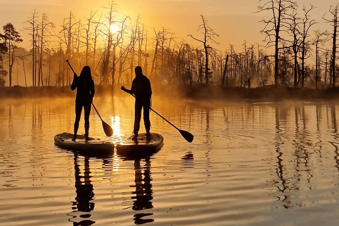 From Riga: Sunrise Kayak or Paddleboard Tour with Pick-Up