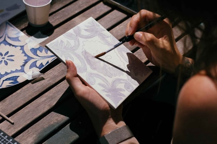 Painting Porto azulejo tile at ceramic studio with artist