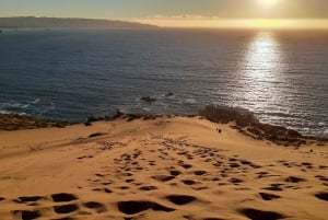 Sandboarden en zonsondergang in de zandduinen van Concon