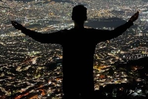 Night tour to 2 viewpoints in Medellín with a bonfire, music, and local flavor.