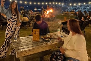 Night tour to 2 viewpoints in Medellín with a bonfire, music, and local flavor.