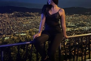 Night tour to 2 viewpoints in Medellín with a bonfire, music, and local flavor.