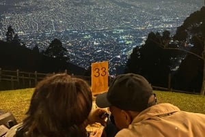 Night tour to 2 viewpoints in Medellín with a bonfire, music, and local flavor.