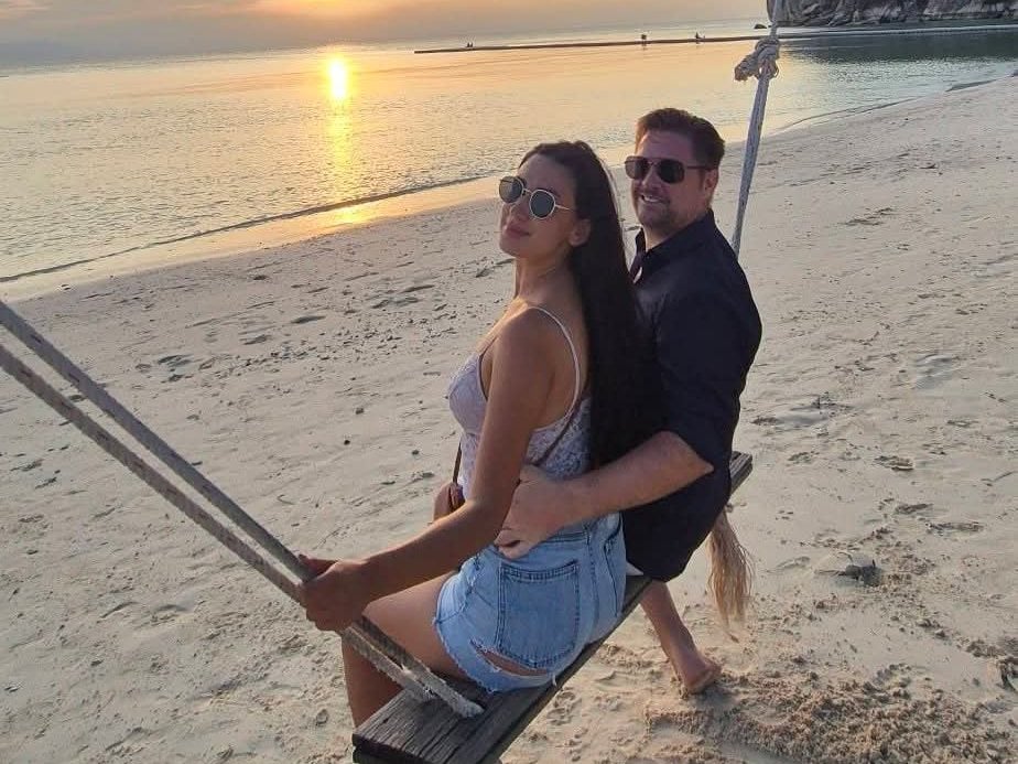 Mark on a beach swing at sunset