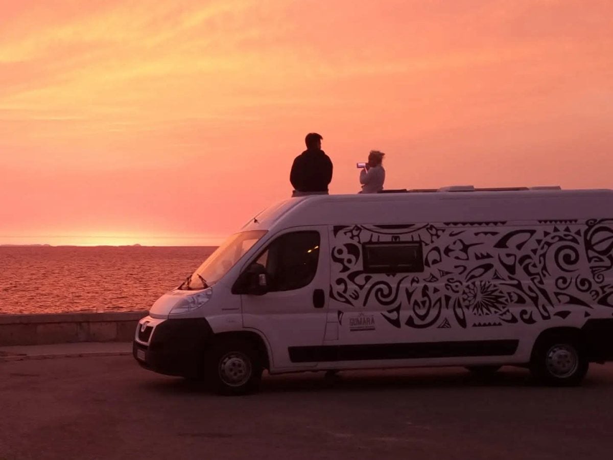 Watching the sunset from the roof of a campervan