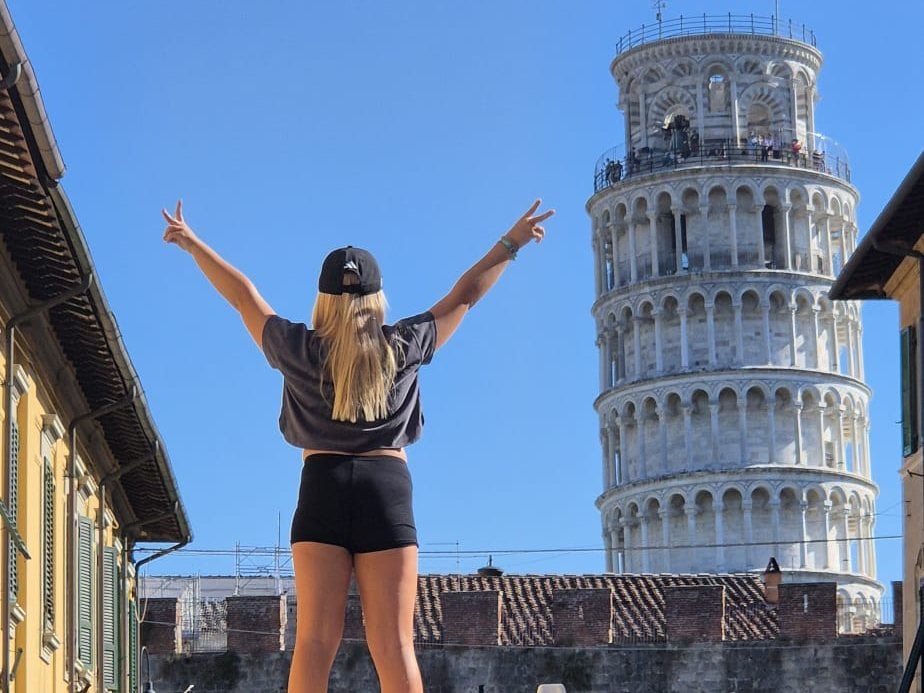 Standing on the van roof in front of the Leaning Tower of Pisa