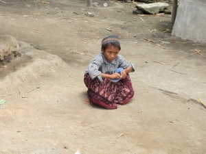 Boy fixing his sandal