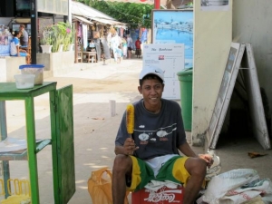 Man selling bbqed corn