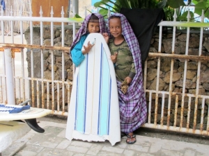 School boys with a broken surboard