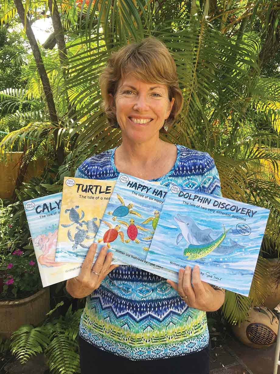 Sue Trew displaying her series of children's books