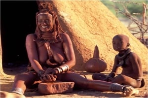 Himba lady preparing Ocre paste