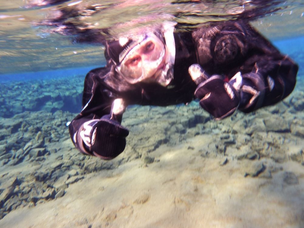 Yours truly, the author of this article, snorkeling in Silfra tectonic rift in Thingvellir, Iceland